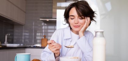 a woman sitting at a table with a plate of food