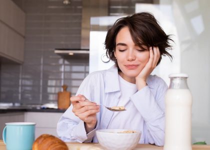 a woman sitting at a table with a plate of food